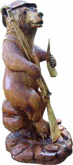 chainsaw bear carving. Features bear hunter with old muzzle loader and powder horn.Carved in 2015